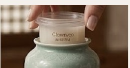 Hand opening a Glowryeo refill jar